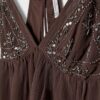 Top met bandjes en borduursels